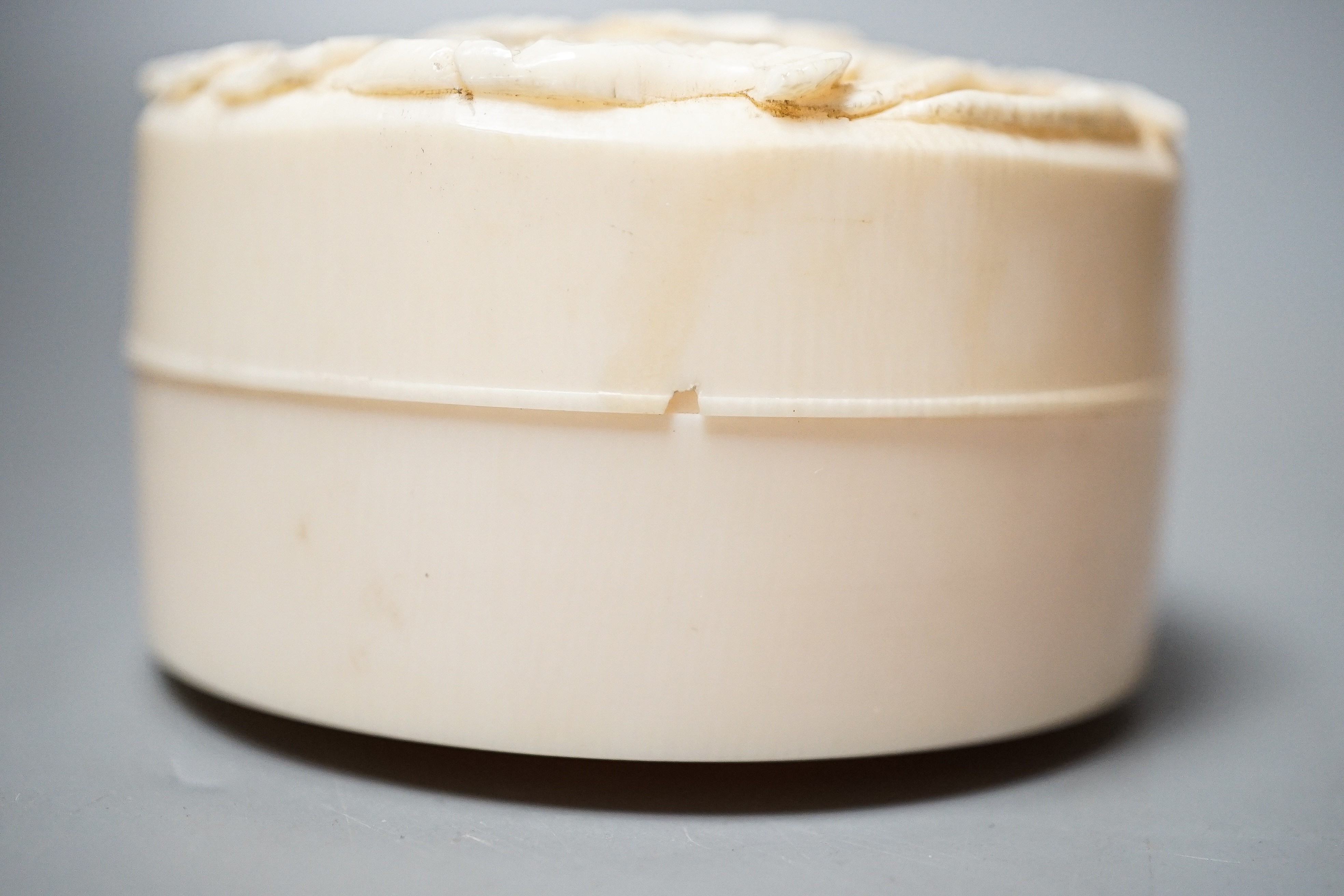 A Meiji period Japanese carved ivory lidded box 6.5cm diameter